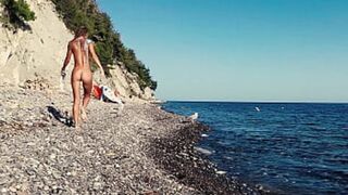Russian teen Sasha Bikeyeva enjoys intimate moments on a bare beach